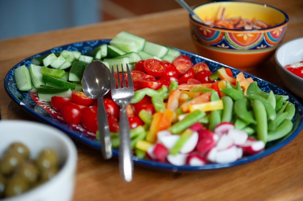 A tasty salad with a bowl of olives