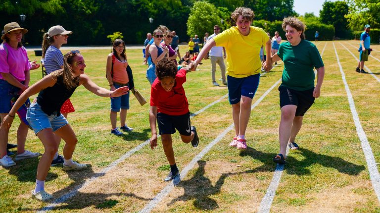 Pupils support each other in a sports day event